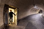 That’s because the Microtron MT25 lab, our destination today, belongs to the Nuclear Physics Institute of the Czech Academy of Sciences (CAS). Just a few dozen meters past the mouth of the tunnel, we come across an inconspicuous door. After knocking, we come face to face with the lab director, David Chvátil.